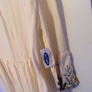 White dress with flowers on bottom and on sleeves